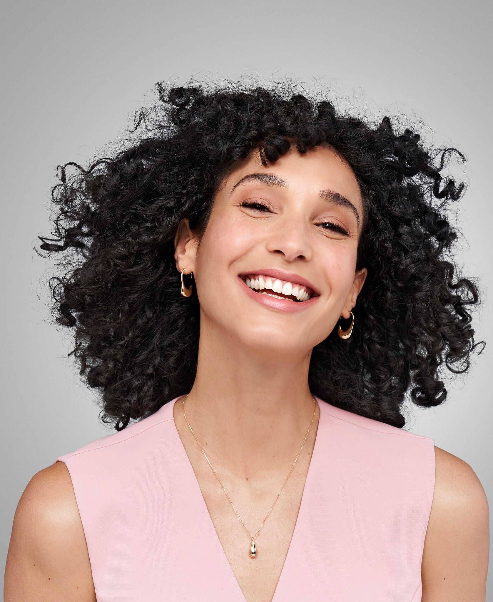 Female looks forward with smile