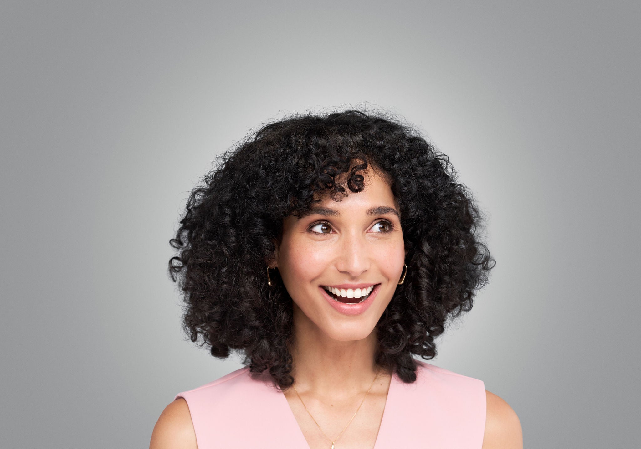 Female looks with smile.